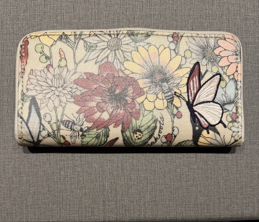 Authentic Sakroots Floral Print Wallet (Category: Wallets & Card holders) located in Valenzuela. Submitted by polchipreloveditems (Listing ID 1421989088, Image 2). Description: - Sakroots floral print wallet - Multiple card slots - Zippered compartment - Clear ID window - Snap closure - Zip-around design - Colorful floral exterior with butterfly accent - Neutral dotted interior lining.