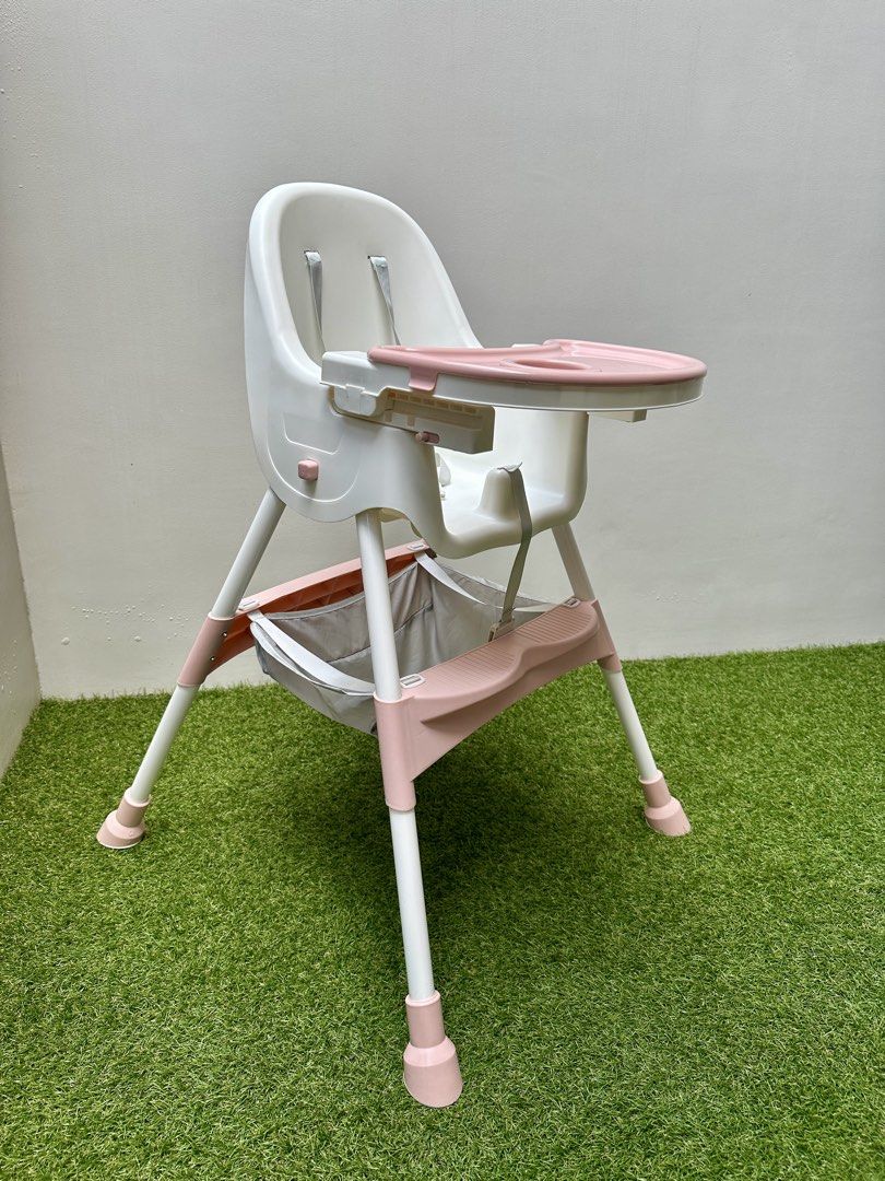 Baby High Chair with Tray (Category: Baby High Chairs) located in Paranaque City. Submitted by every_thingph (Listing ID 1421954324, Image 1). Description: - White and pink high chair - Designed for babies and toddlers - Removable tray for easy cleaning - Includes a safety harness for security - Convenient storage basket - Easy-to-clean plastic seat - Comfortable footrest - Pink accents on legs.