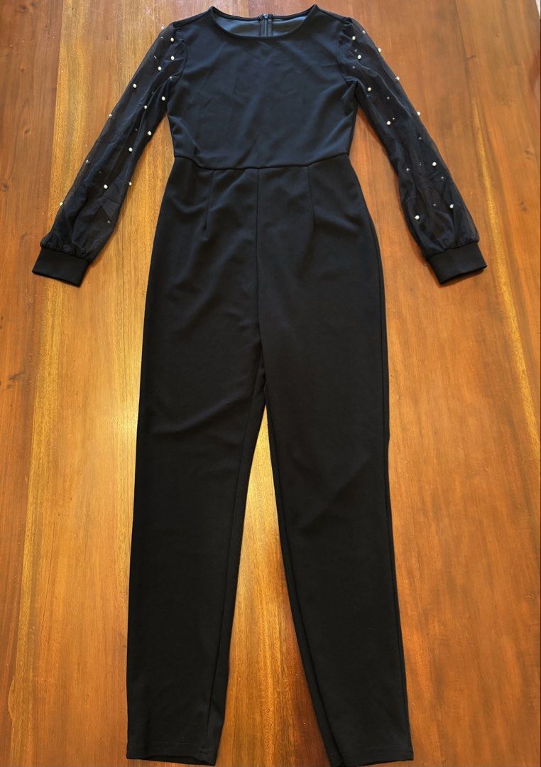 Black Jumpsuit with Pearl Sleeves (Category: Jumpsuits) located in Mandaue City. Submitted by marginiz (Listing ID 1421957900, Image 1). Description: Elegant black jumpsuit featuring a round neckline and long sleeves with pearl embellishments. The jumpsuit has a fitted bodice and straight-leg pants. It includes a zipper closure at the back. The sleeves are made of sheer fabric, adding a touch of sophistication. Note: tag removed for comfort.