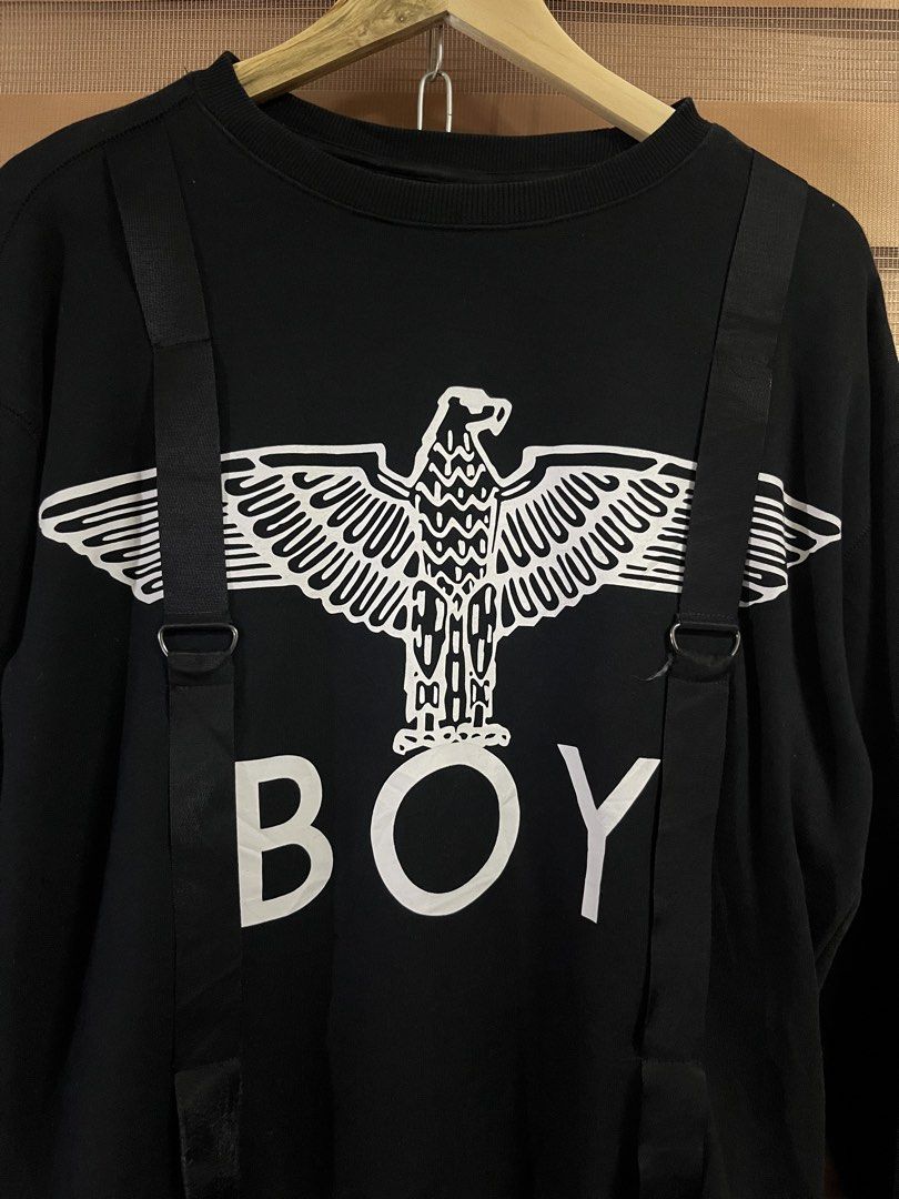 BOY London Black Eagle Logo Sweatshirt with Straps (Category: Coats, Jackets and Outerwear) located in Paranaque City. Submitted by mondaysglory (Listing ID 1422068035, Image 2). Description: BOY London Black Eagle Logo Sweatshirt with Straps L - 26 W - 22 Color rate: 9.5/10 Condition: Very Good Need wash - Black Boy London sweatshirt - Features an eagle graphic and "BOY" print - Decorative straps - Size: XS - Back: Vertical strap and Boy London 