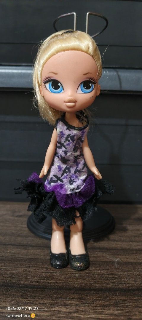 Bratz Lil' Angelz Doll (Category: Kids Toys) located in Manila. Submitted by alhaina (Listing ID 1422035445, Image 2). Description: - Bratz Lil' Angelz doll - Features blonde hair and blue eyes - Wearing a purple and black dress with matching shoes.