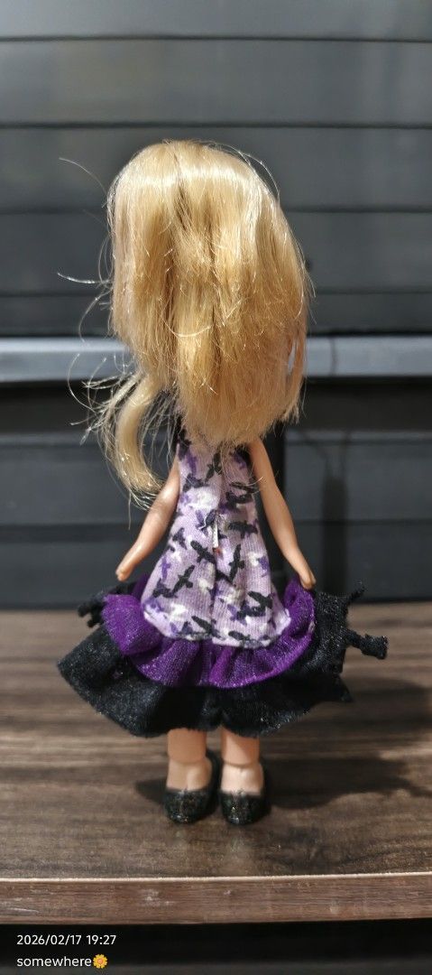 Bratz Lil' Angelz Doll (Category: Kids Toys) located in Manila. Submitted by alhaina (Listing ID 1422035445, Image 3). Description: - Bratz Lil' Angelz doll - Features blonde hair and blue eyes - Wearing a purple and black dress with matching shoes.