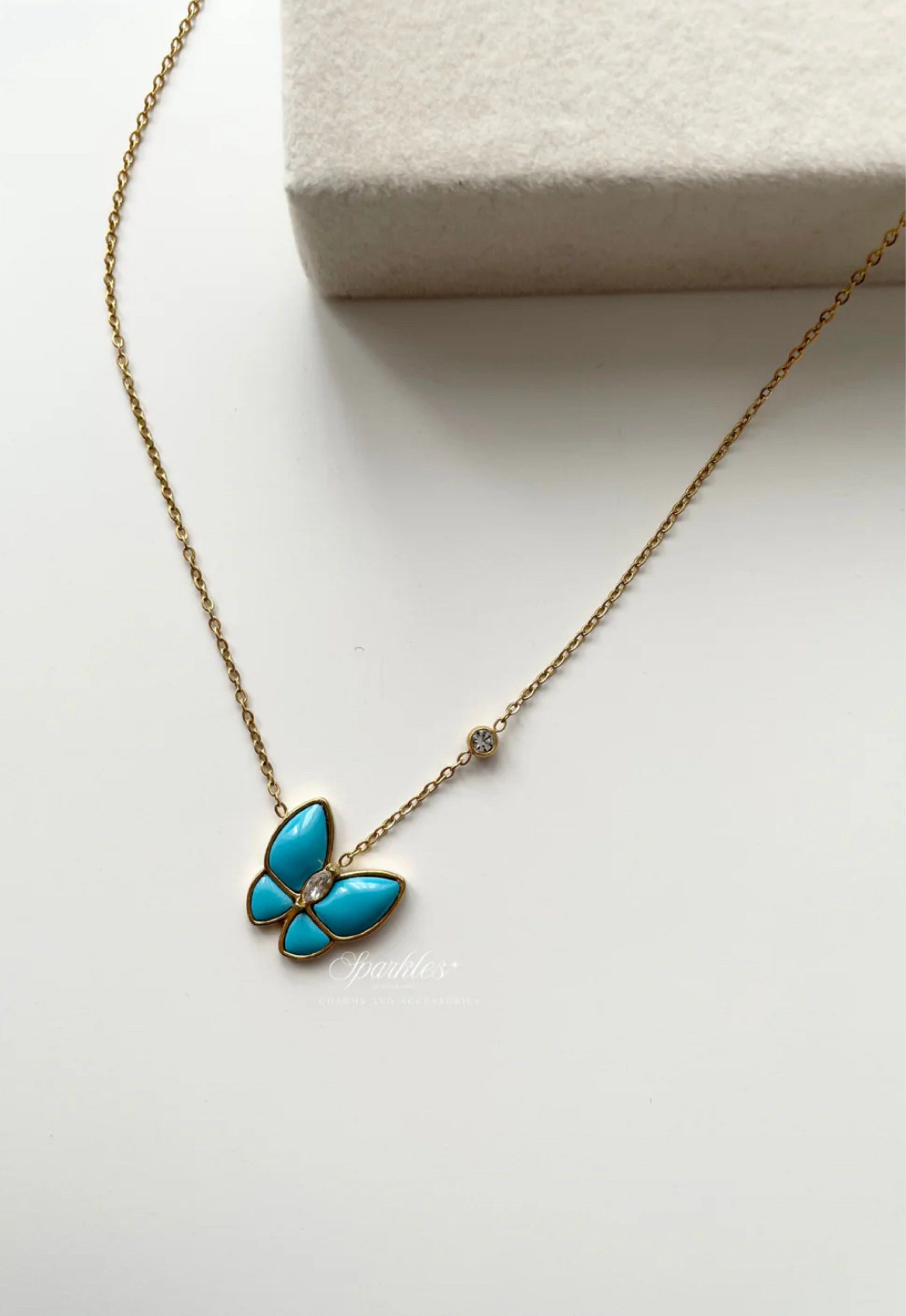 Butterfly Pendant Necklace (Category: Necklaces) located in Paranaque City. Submitted by seektoshop (Listing ID 1422025953, Image 3). Description: - Gold-toned butterfly pendant - Turquoise-colored wings - Clear stone center - Delicate gold chain - Small clear stone accent on chain - Suitable for everyday wear and special occasions - stainless steel - 14k gold plated, tarnish free - skin friendly .