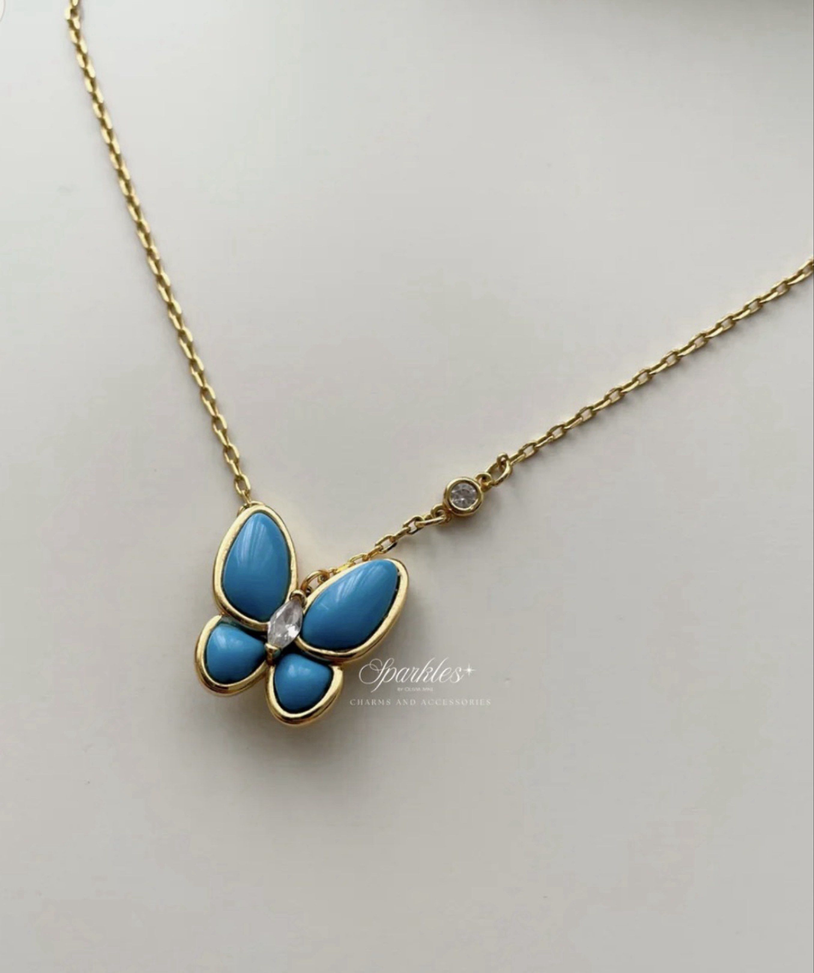 Butterfly Pendant Necklace (Category: Necklaces) located in Paranaque City. Submitted by seektoshop (Listing ID 1422025953, Image 2). Description: - Gold-toned butterfly pendant - Turquoise-colored wings - Clear stone center - Delicate gold chain - Small clear stone accent on chain - Suitable for everyday wear and special occasions - stainless steel - 14k gold plated, tarnish free - skin friendly .