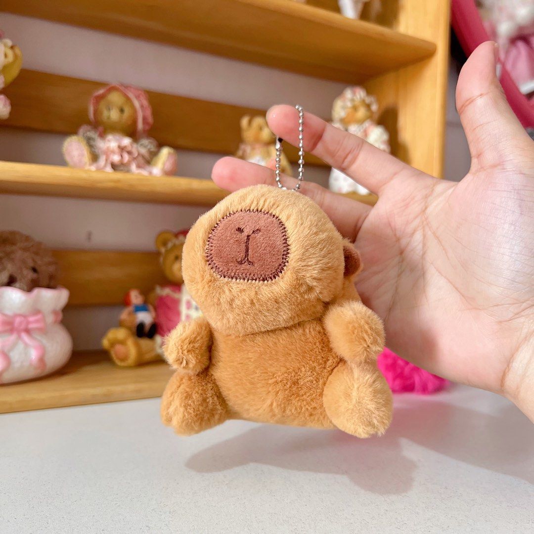 Capybara Classic Charm bag (Category: Plushies & Soft Toys) located in Manila. Submitted by ashyyel_ (Listing ID 1422017552, Image 1). Description: - Adorable monkey plush keychain - Soft, brown plush material - Features a stitched face - Includes a silver chain for easy attachment - Compact size, perfect as an accessory.