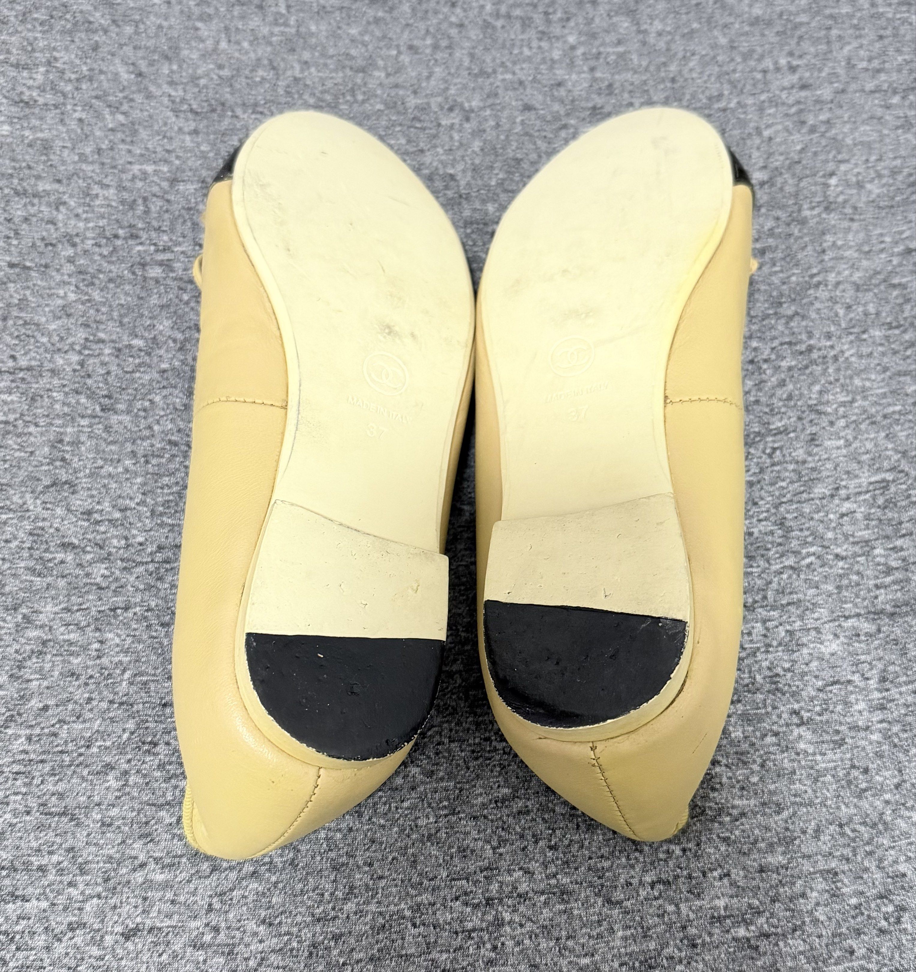 Chanel Cap-Toe Ballet Flats (Category: Flats & Sandals) located in Manila. Submitted by heypreloved2016 (Listing ID 1422029248, Image 2). Description: - Authentic Chanel ballet flats - Beige leather upper - Black cap toe - Features a small bow detail - Beige leather interior with Chanel logo - Size 37 - Soles show wear.