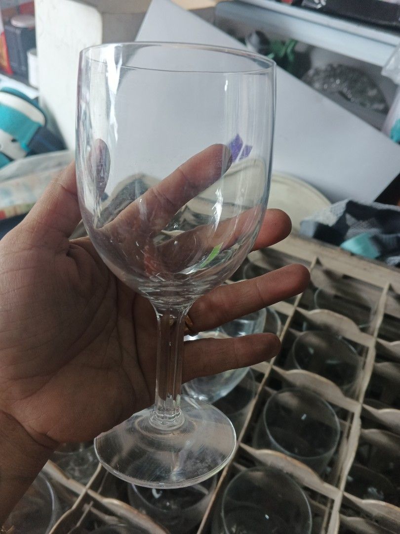 Clear Wine Glasses w/ crates (Category: Other Kitchenware & Tableware) located in Caloocan City. Submitted by surplusandbnewshop (Listing ID 1421986679, Image 1). Description: - Classic stemware design - Suitable for wine and other beverages - Stored in a rack (likely part of a set).