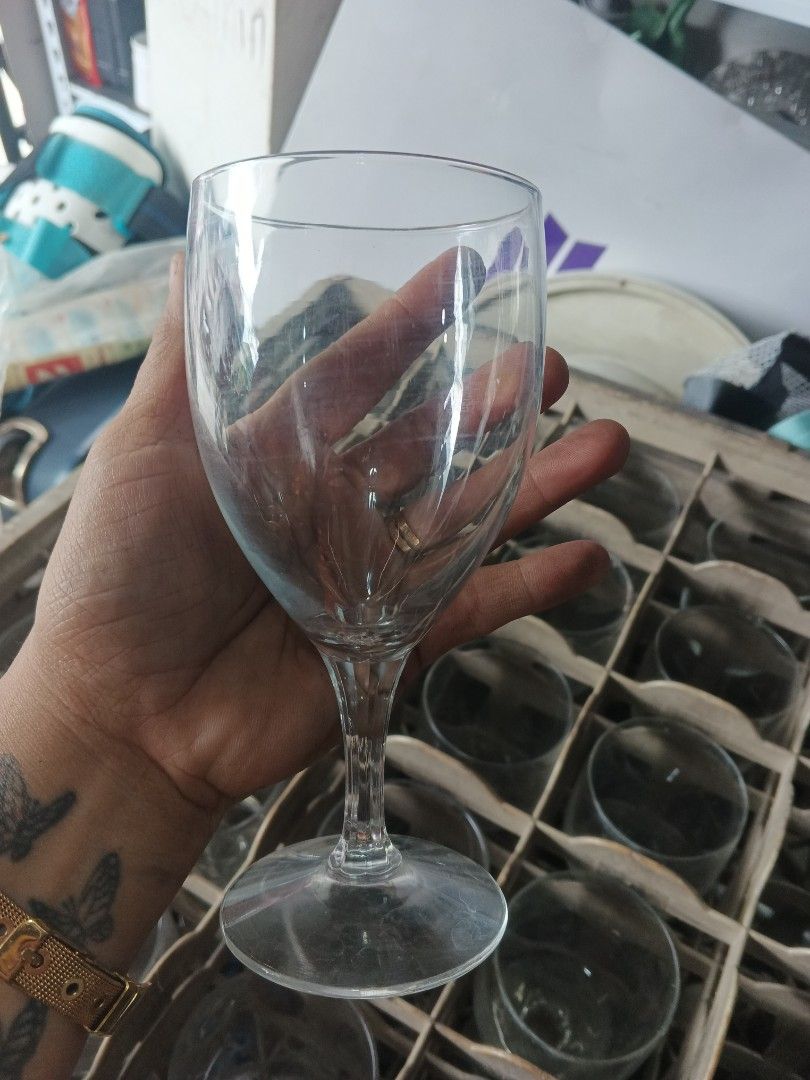 Clear Wine Glasses w/ crates (Category: Other Kitchenware & Tableware) located in Caloocan City. Submitted by surplusandbnewshop (Listing ID 1421986679, Image 2). Description: - Classic stemware design - Suitable for wine and other beverages - Stored in a rack (likely part of a set).