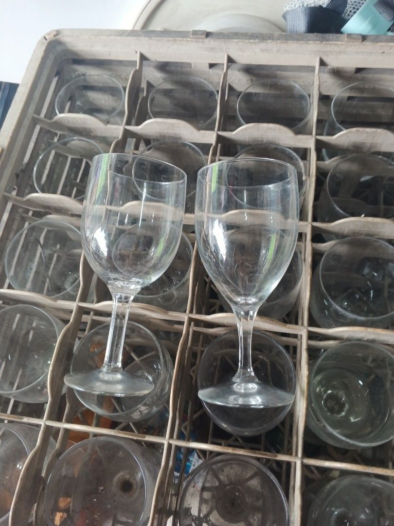 Clear Wine Glasses w/ crates (Category: Other Kitchenware & Tableware) located in Caloocan City. Submitted by surplusandbnewshop (Listing ID 1421986679, Image 3). Description: - Classic stemware design - Suitable for wine and other beverages - Stored in a rack (likely part of a set).