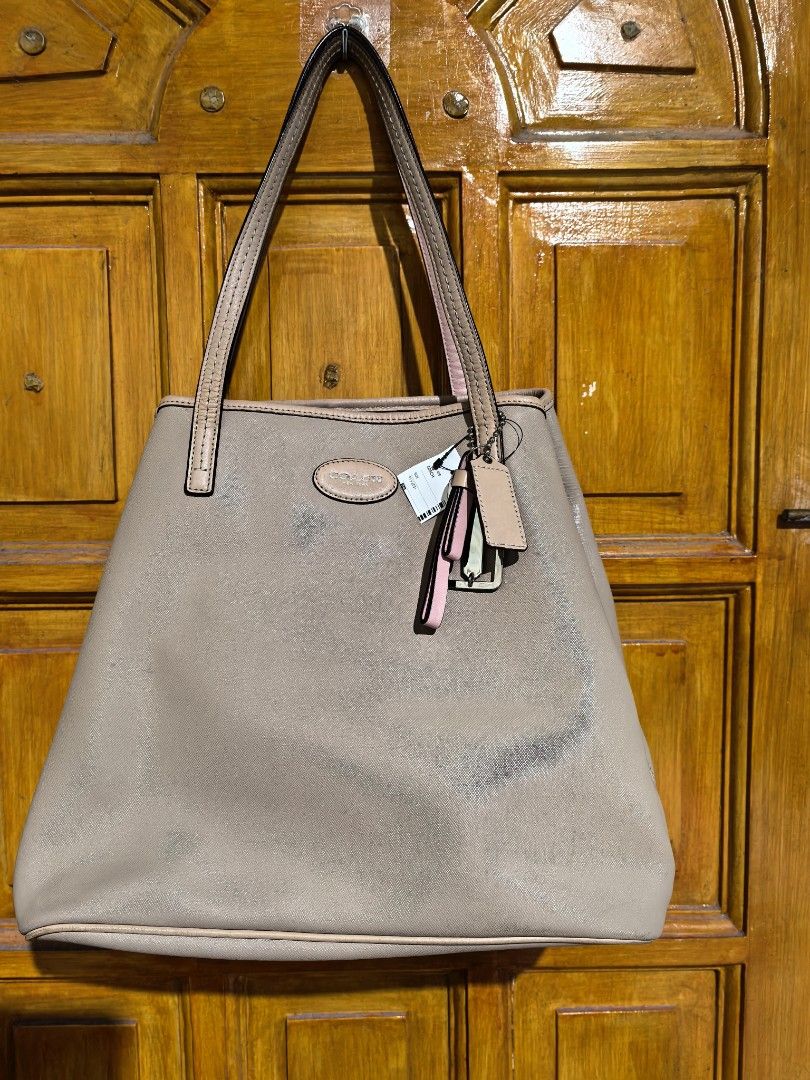 Coach Patent Leather 2-Way Bag (Category: Luxury Bags & Wallets) located in Manila. Submitted by khulet2008 (Listing ID 1422047476, Image 2). Description: - Coach leather - Neutral color - Tote design with double handles - Interior pockets, including one with a zipper - Features Coach logo - pretty in actual. Condition: 9/10.