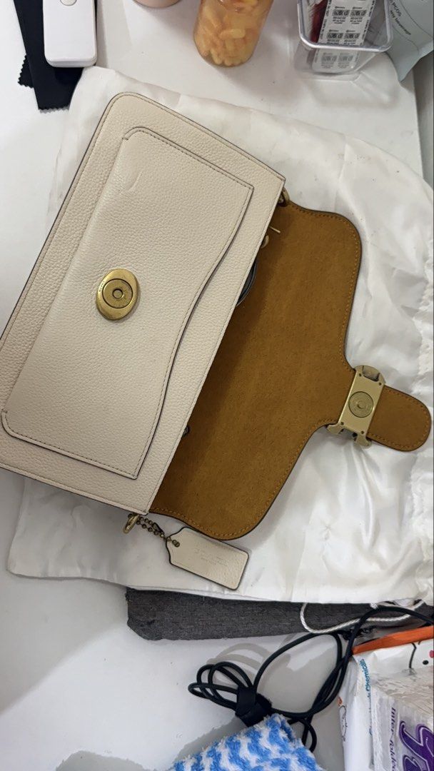 Coach Tabby Shoulder Bag (Category: Luxury Bags & Wallets) located in Zamboanga. Submitted by princessdi09838 (Listing ID 1421971750, Image 3). Description: - Coach Tabby - Light cream color - Detachable shoulder strap - Includes dust bag - Made of leather -Needs Cleaning -Issues: Small dent infront & scratches inside magnetic lock .