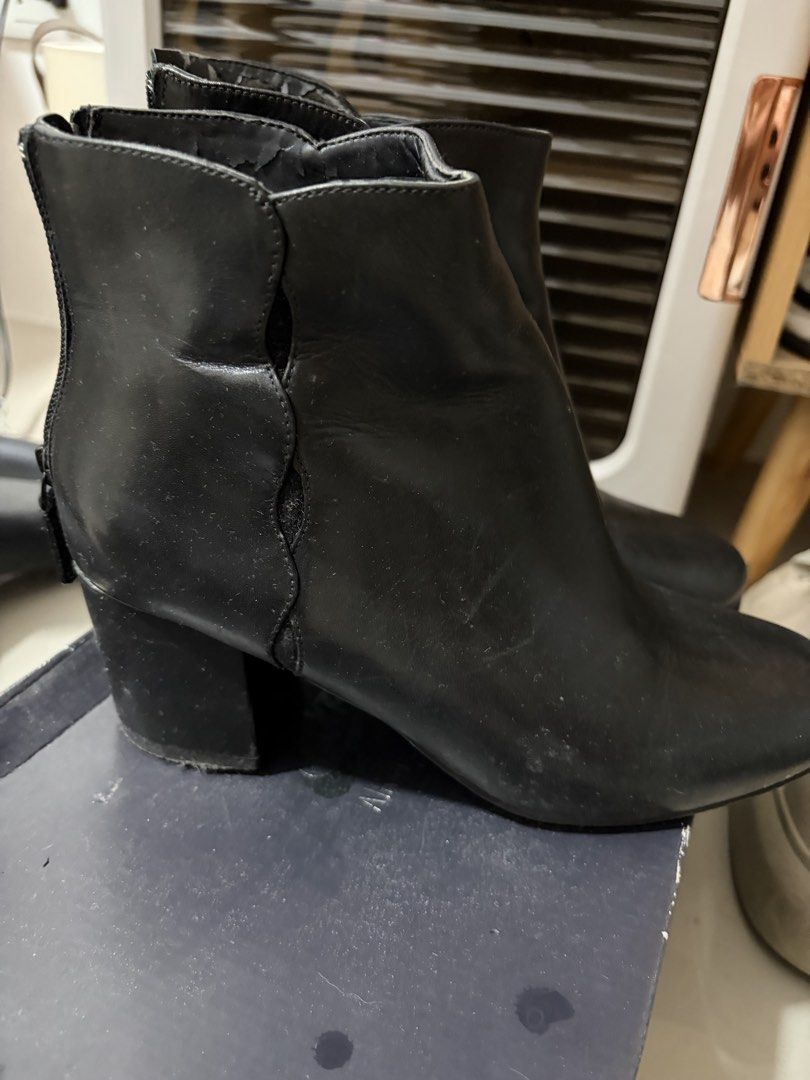 Cole Haan Black Ankle Boots (Category: Boots) located in Mandaluyong City. Submitted by getbounced (Listing ID 1422024702, Image 2). Description: Black Cole Haan ankle boots. Features a scalloped design on the side and a block heel. The size is 7B. The interior of the boots has the Cole Haan logo. Zippers are visible on the back of the boots..