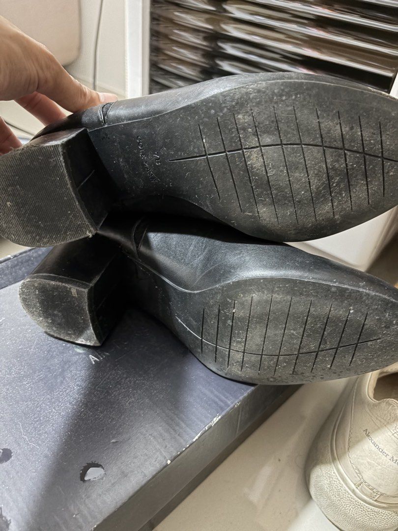 Cole Haan Black Ankle Boots (Category: Boots) located in Mandaluyong City. Submitted by getbounced (Listing ID 1422024702, Image 3). Description: Black Cole Haan ankle boots. Features a scalloped design on the side and a block heel. The size is 7B. The interior of the boots has the Cole Haan logo. Zippers are visible on the back of the boots..