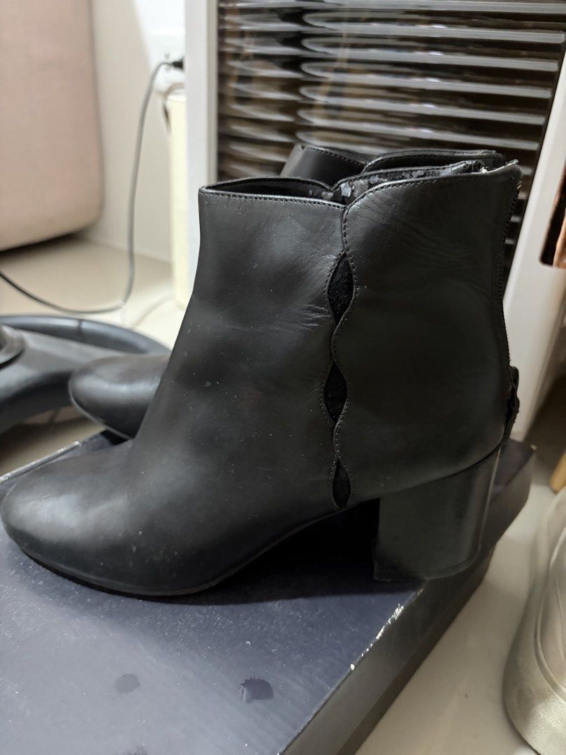 Cole Haan Black Ankle Boots (Category: Boots) located in Mandaluyong City. Submitted by getbounced (Listing ID 1422024702, Image 1). Description: Black Cole Haan ankle boots. Features a scalloped design on the side and a block heel. The size is 7B. The interior of the boots has the Cole Haan logo. Zippers are visible on the back of the boots..