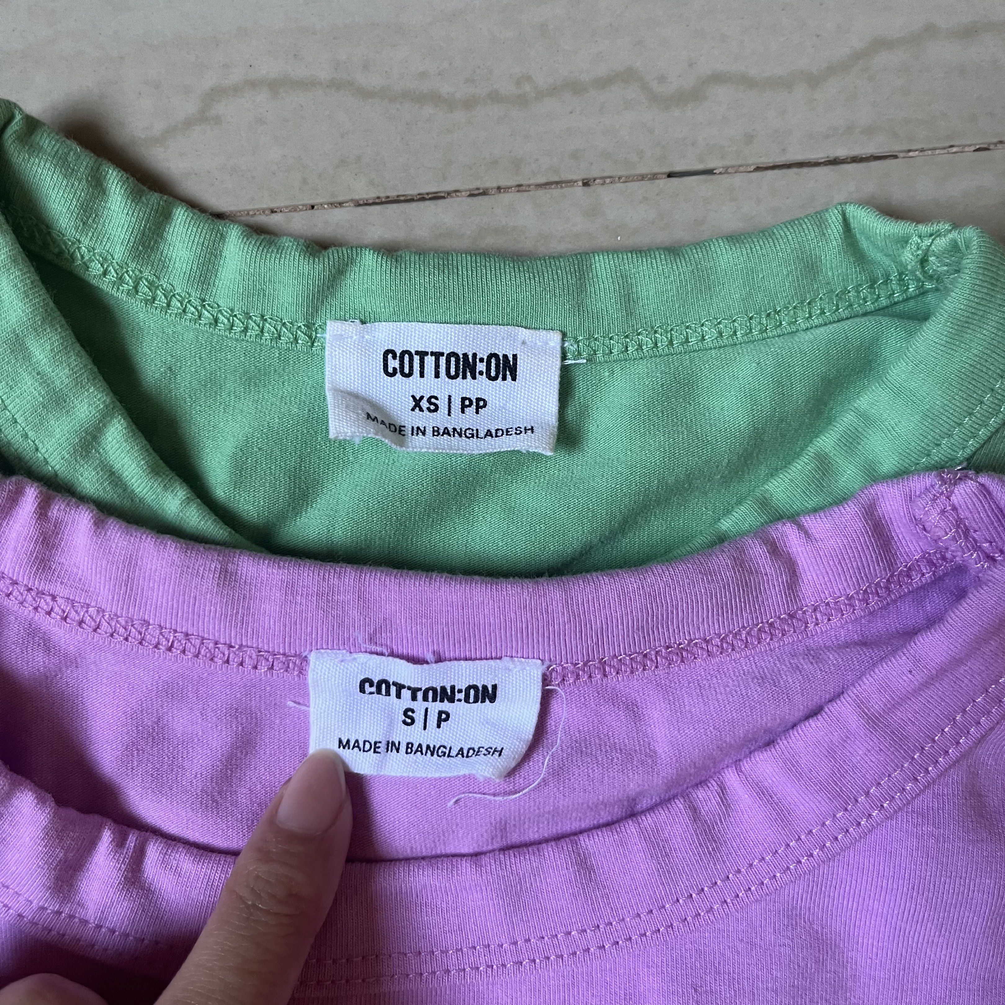 Cotton On Crop set (Category: Shirts) located in San Pedro. Submitted by tinybubbless (Listing ID 1421955599, Image 2). Description: - Cotton On crop tops - Colors: Green (XS), Purple (S) - Features: Round neckline, short sleeves - Made in Bangladesh - Perfect for casual wear.