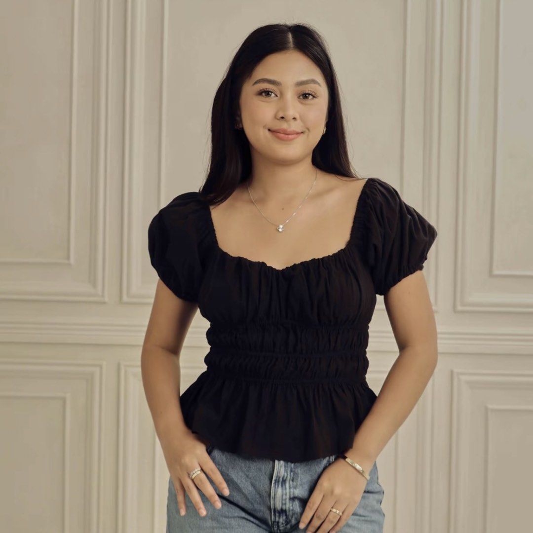 Dominique & Co. Black Puff Sleeve Top (Category: Blouses) located in Pateros City. Submitted by lelieldbj (Listing ID 1422009801, Image 1). Description: - Black top - Square neckline - Puff sleeves - Fitted bodice with shirring - Peplum hem - Solid black color - Lightweight fabric - Dress up or down.