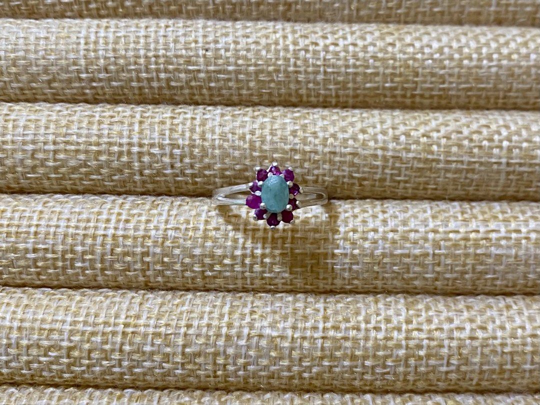 Emerald and Ruby Gemstone Ring | S925 (Category: Rings) located in Solano. Submitted by silvershineph (Listing ID 1421947636, Image 1). Description: ✧ Product / Item Name: Emerald and Ruby Gemstone Ring ✧ Description: It features a central oval-cut light green gemstone, identified as an emerald in similar designs. This central stone is surrounded by a cluster of smaller, vibrant pink-red gemstones, which are rubies. ✧ Size: 7 ✧ Weight: 2.5g ✧ Det