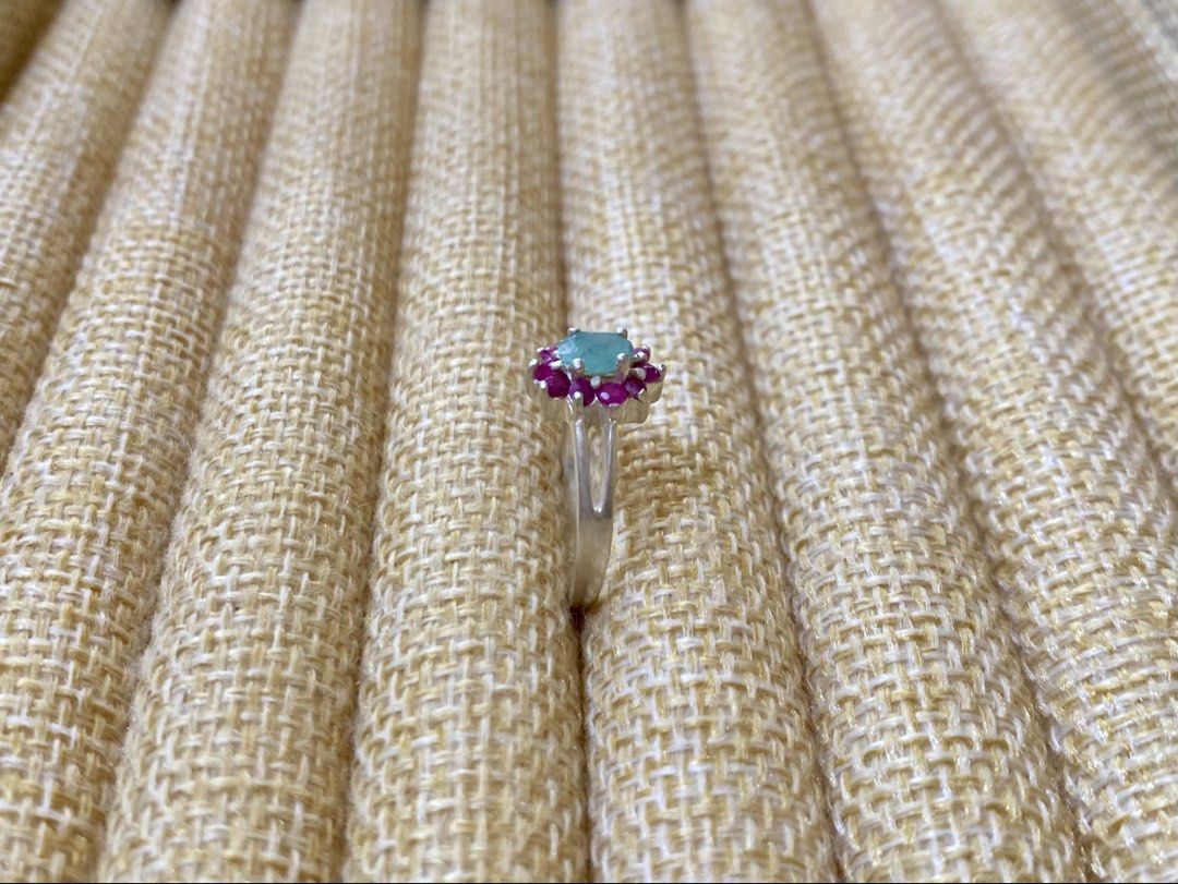 Emerald and Ruby Gemstone Ring | S925 (Category: Rings) located in Solano. Submitted by silvershineph (Listing ID 1421947636, Image 2). Description: ✧ Product / Item Name: Emerald and Ruby Gemstone Ring ✧ Description: It features a central oval-cut light green gemstone, identified as an emerald in similar designs. This central stone is surrounded by a cluster of smaller, vibrant pink-red gemstones, which are rubies. ✧ Size: 7 ✧ Weight: 2.5g ✧ Det