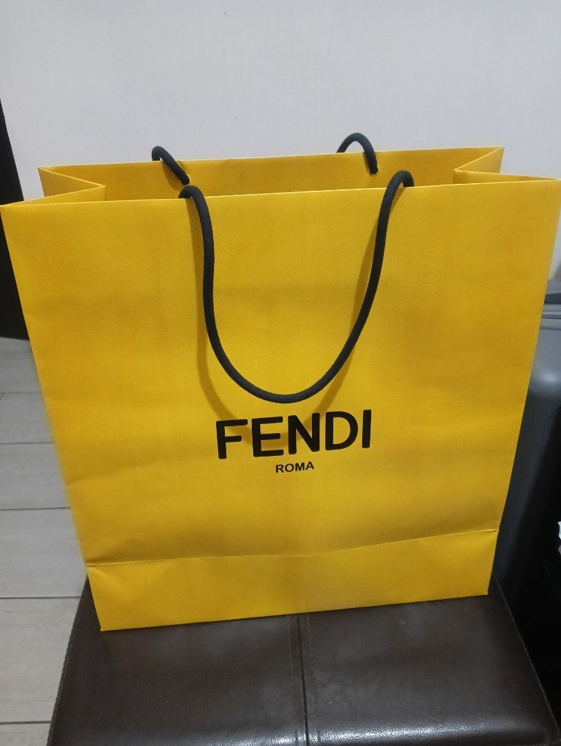 Fendi paper bag (Category: Luxury Bags & Wallets) located in Makati City. Submitted by maloustuffs_2025 (Listing ID 1421990080, Image 1). Description: - Authentic Fendi paperbag - Bright yellow color - Black handles - Black Fendi logo print - Stylish design - Ideal for carrying purchases - Dimensions: H 35.3cm×L 33.5×W 14cm.
