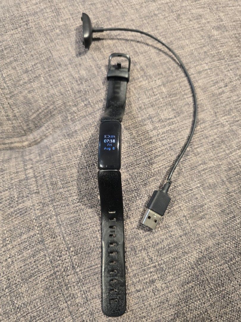 Fitbit Inspire HR Fitness Tracker (Category: Wearables & Smart Watches) located in Makati City. Submitted by everydaytrinkets (Listing ID 1422032520, Image 1). Description: - Black Fitbit Inspire HR fitness tracker - Displays time and other metrics - Black band with adjustable holes - Includes charging cable - In good working condition -strap shows sign of use -price is negotiable.