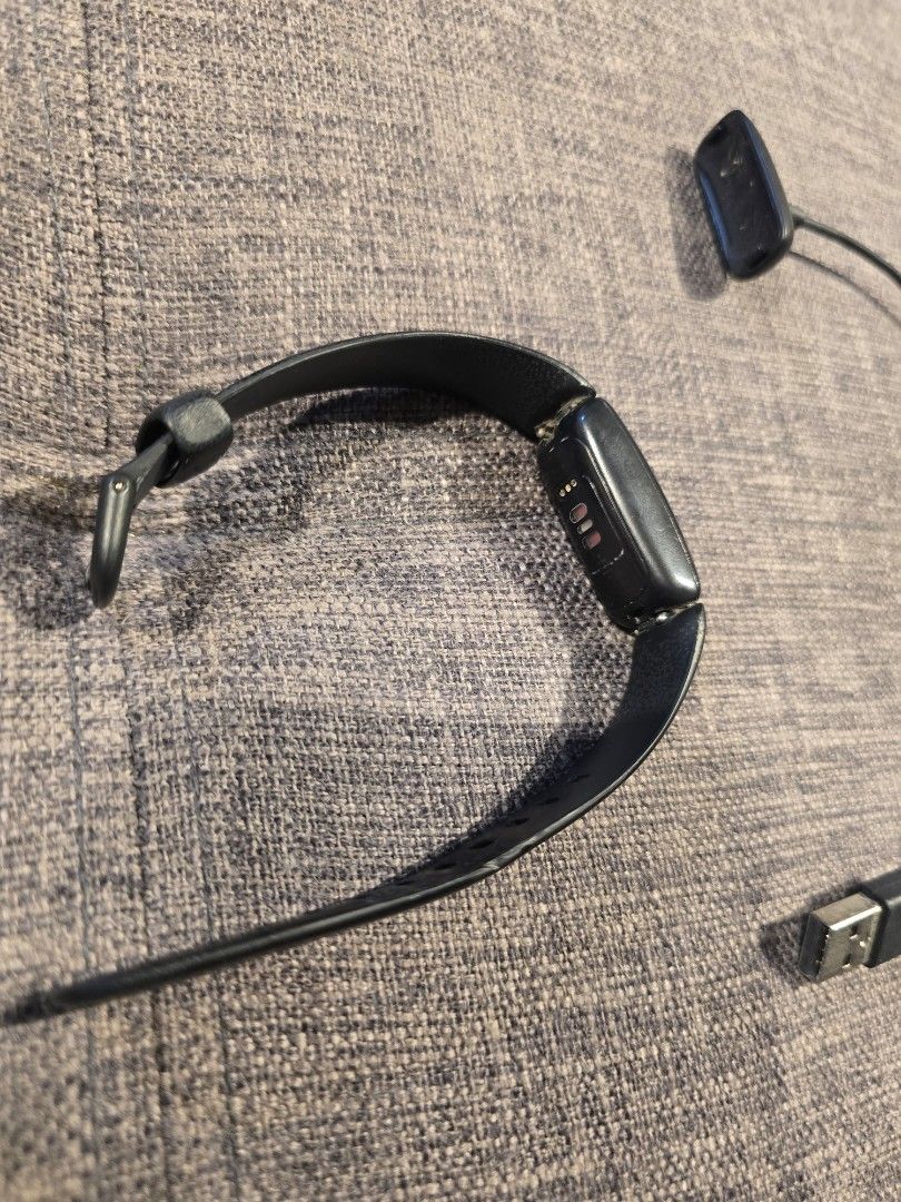 Fitbit Inspire HR Fitness Tracker (Category: Wearables & Smart Watches) located in Makati City. Submitted by everydaytrinkets (Listing ID 1422032520, Image 2). Description: - Black Fitbit Inspire HR fitness tracker - Displays time and other metrics - Black band with adjustable holes - Includes charging cable - In good working condition -strap shows sign of use -price is negotiable.