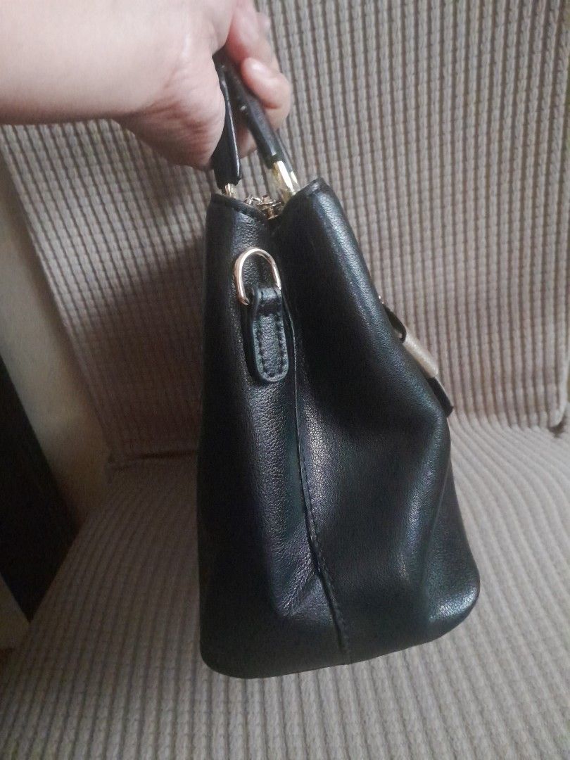 Foxer Black Handbag with Bow Detail (Category: Luxury Bags & Wallets) located in Quezon City. Submitted by lalaine.r (Listing ID 1421952012, Image 3). Description: - Foxer black handbag - Stylish bow detail - Top handle - Back zippered pocket - Spacious interior with small inner pocket - Gold-toned hardware - Structured design - Perfect for everyday or special occasions - Issue: Missing Sling.