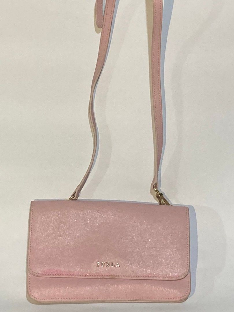 Furla Pink Crossbody Bag (Category: Luxury Bags & Wallets) located in Taguig. Submitted by blessedlupie (Listing ID 1422027024, Image 1). Description: - Authentic Furla crossbody bag - Light pink color - Flap closure - Adjustable long strap for shoulder or crossbody wear - Rectangular shape - Furla logo on the front.