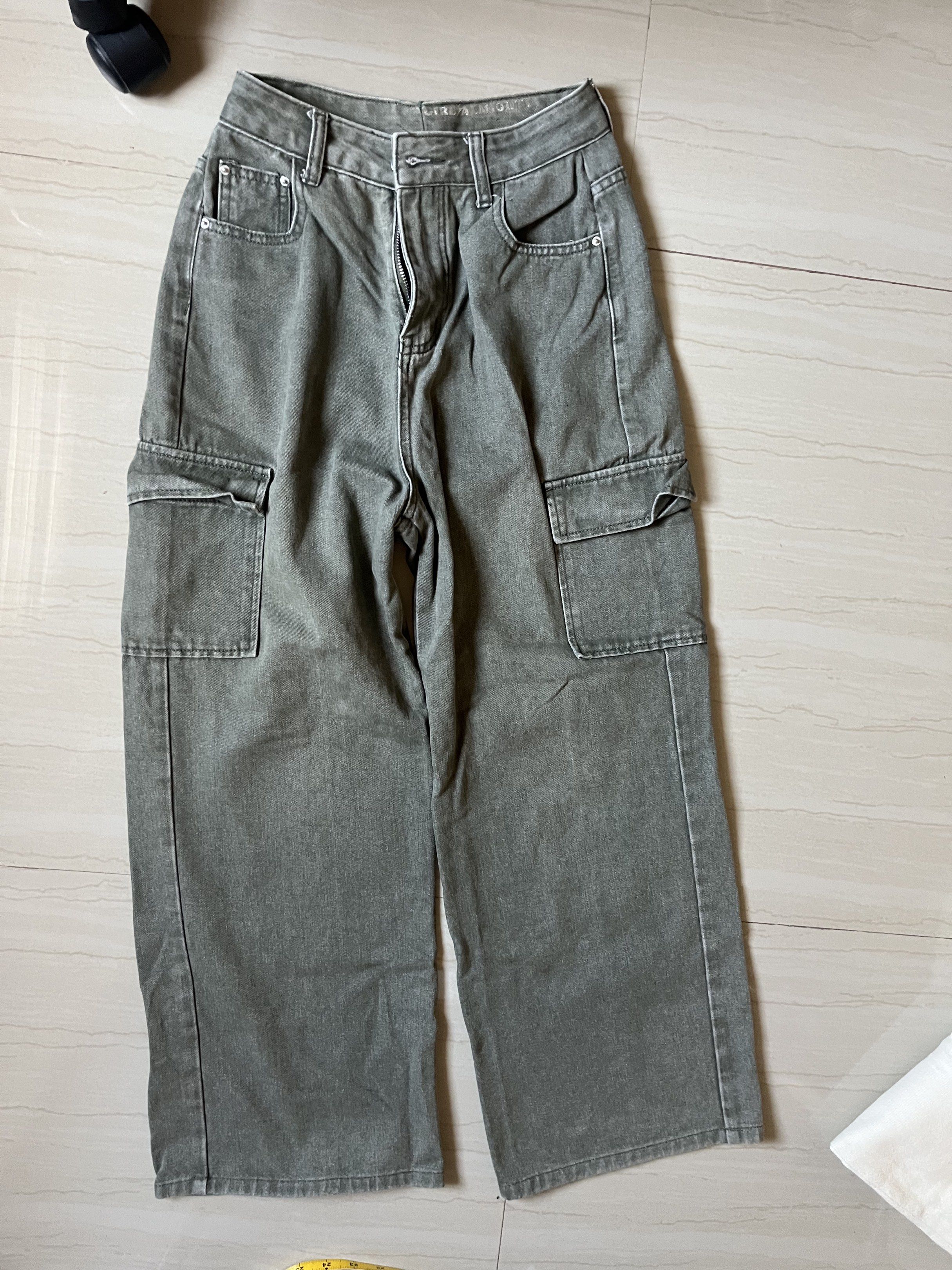 Girl Almighty Cargo Jeans (Category: Jeans) located in San Pedro. Submitted by tinybubbless (Listing ID 1421957739, Image 1). Description: - Girl Almighty cargo jeans - 25 - 26 waistline - Wide-leg design - Muted green color - Two front pockets - Two cargo pockets - Button and zipper closure - Perfect for everyday wear.