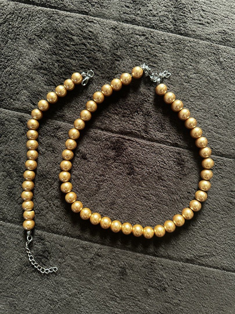 Gold Bead Necklace and Bracelet Set (Category: Necklaces) located in Makati City. Submitted by prelovedbymba (Listing ID 1422003919, Image 3). Description: - Gold bead necklace and bracelet set - Features round, golden beads - Silver-colored clasps - Adjustable chains - Adds sophistication to any outfit - Ideal for special occasions or everyday wear.