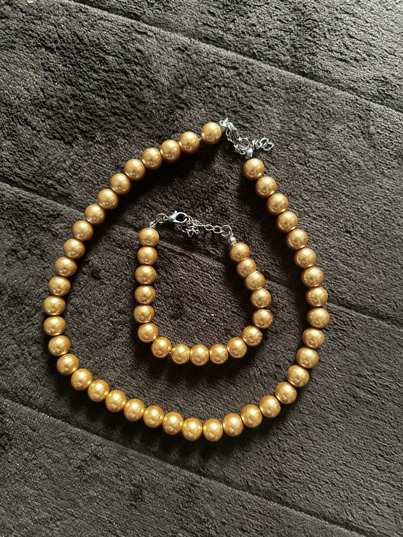 Gold Bead Necklace and Bracelet Set (Category: Necklaces) located in Makati City. Submitted by prelovedbymba (Listing ID 1422003919, Image 2). Description: - Gold bead necklace and bracelet set - Features round, golden beads - Silver-colored clasps - Adjustable chains - Adds sophistication to any outfit - Ideal for special occasions or everyday wear.