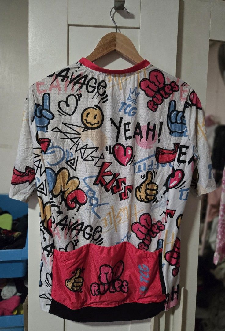 Graphic Print Jersey (Category: Activewear) located in Quezon City. Submitted by ddlry (Listing ID 1422003786, Image 2). Description: - White jersey - Full-length zipper - Short sleeves - Colorful graphic print with "SAVAGE", "YEAH!", and "KISS" - Pink back pocket area - Black collar trim.