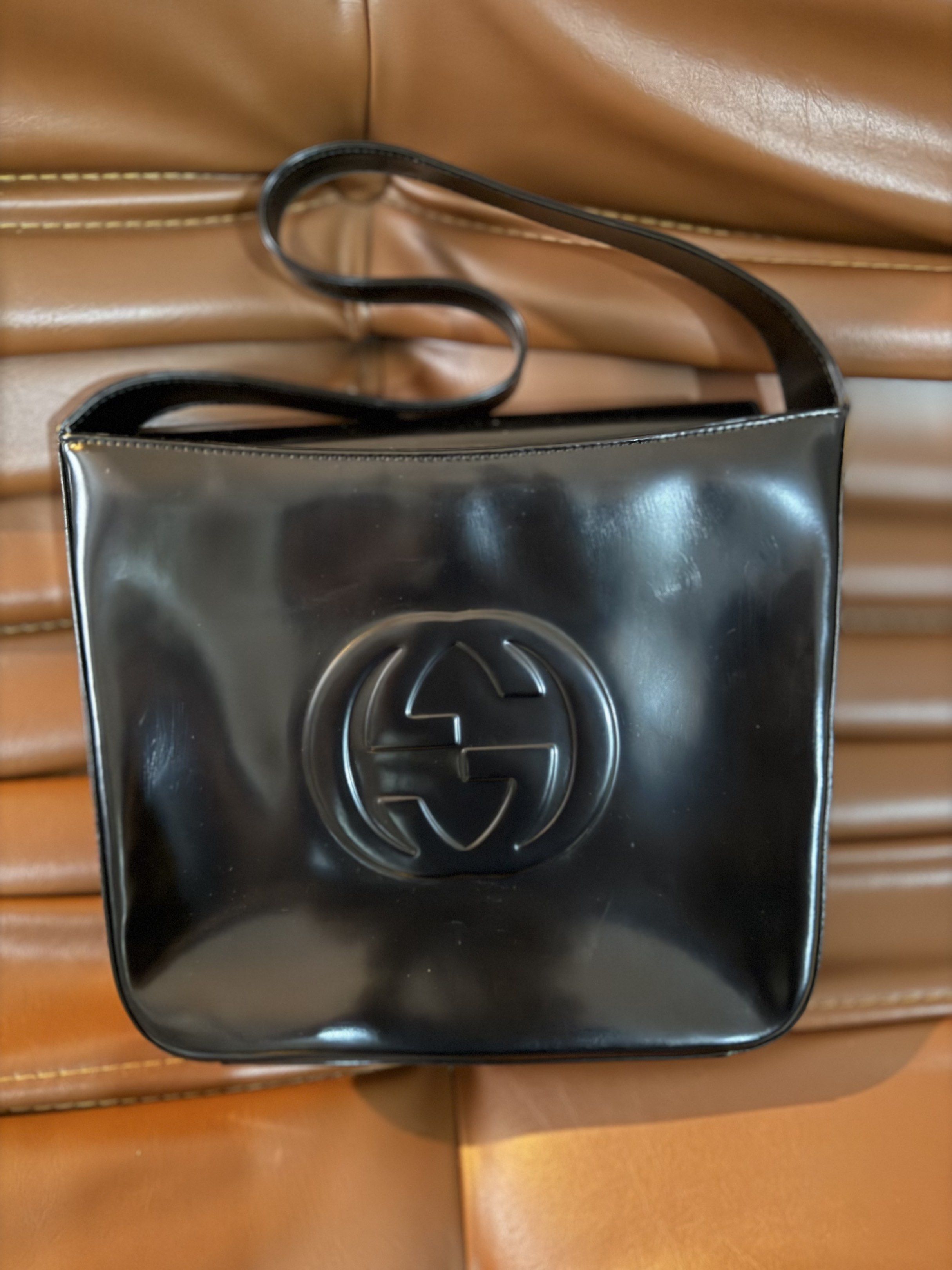 Gucci G Vintage Top Bag (Category: Luxury Bags & Wallets) located in Pateros City. Submitted by norskieonlineshop (Listing ID 1421948847, Image 2). Description: This Gucci Interlocking G Vintage Top Handle Shoulder Bag is crafted from black box leather, showcasing a classic and elegant design. The bag features a magnetic closure, silver hardware, and a shoulder strap with a 6-inch drop. With dimensions of 7.5 inches in width, 6.25 inches in heigh