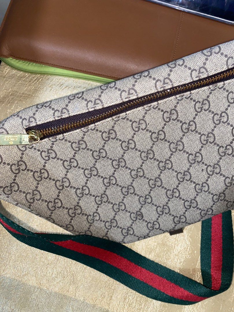 Gucci GG Supreme Belt Bag (Category: Luxury Bags & Wallets) located in Paranaque City. Submitted by charles_delfin44 (Listing ID 1422056508, Image 2). Description: - Authentic Gucci belt bag - Iconic GG Supreme canvas - Brown leather handle - Green and red striped strap - Gold zipper - Brown leather trim - Stylish and practical design.