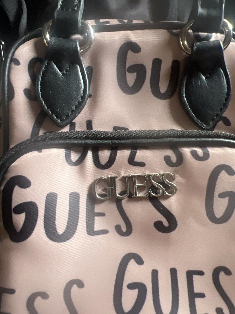 Guess Allover Crossbody Bag (Category: Cross-body Bags) located in Taguig. Submitted by stuffitlikeitshot (Listing ID 1421958062, Image 2). Description: - Guaranteed ORIG from CA - Used twice ONLY - fits Iphone promax - Tan color with black accents - Includes a top handle and detachable shoulder strap - Front pocket for easy access - Guess logo printed on the strap.