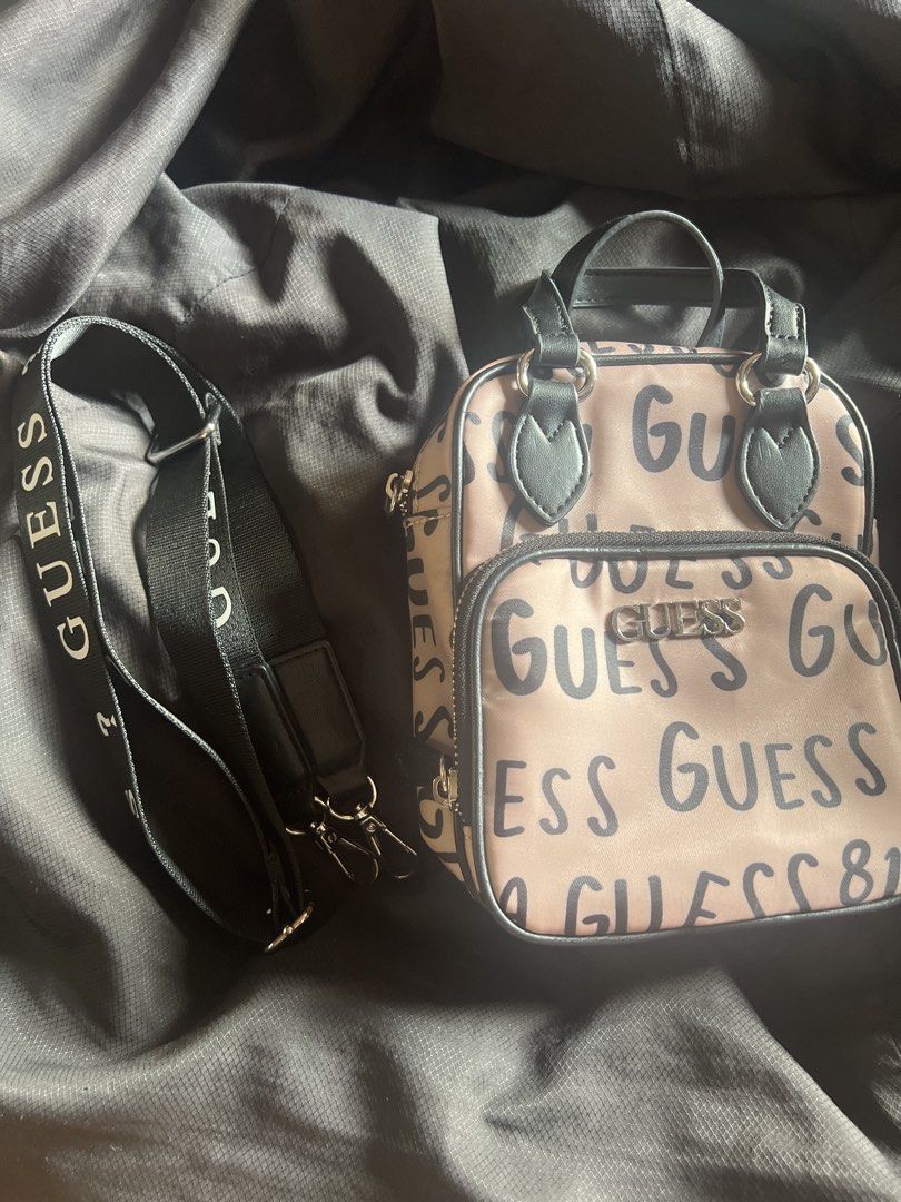 Guess Allover Crossbody Bag (Category: Cross-body Bags) located in Taguig. Submitted by stuffitlikeitshot (Listing ID 1421958062, Image 3). Description: - Guaranteed ORIG from CA - Used twice ONLY - fits Iphone promax - Tan color with black accents - Includes a top handle and detachable shoulder strap - Front pocket for easy access - Guess logo printed on the strap.