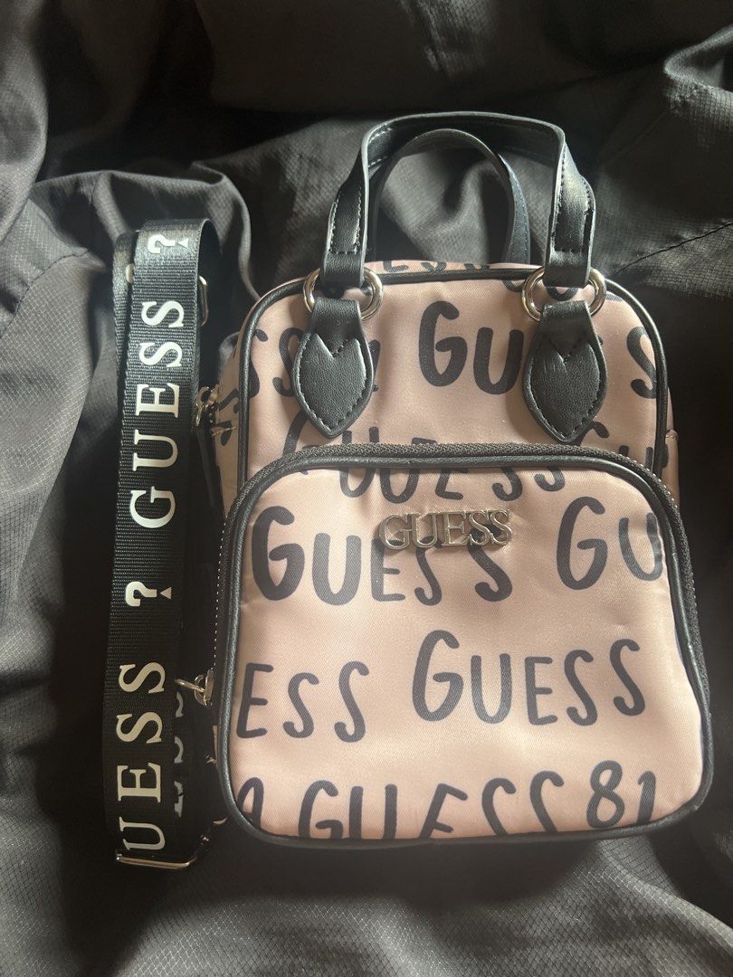 Guess Allover Crossbody Bag (Category: Cross-body Bags) located in Taguig. Submitted by stuffitlikeitshot (Listing ID 1421958062, Image 1). Description: - Guaranteed ORIG from CA - Used twice ONLY - fits Iphone promax - Tan color with black accents - Includes a top handle and detachable shoulder strap - Front pocket for easy access - Guess logo printed on the strap.