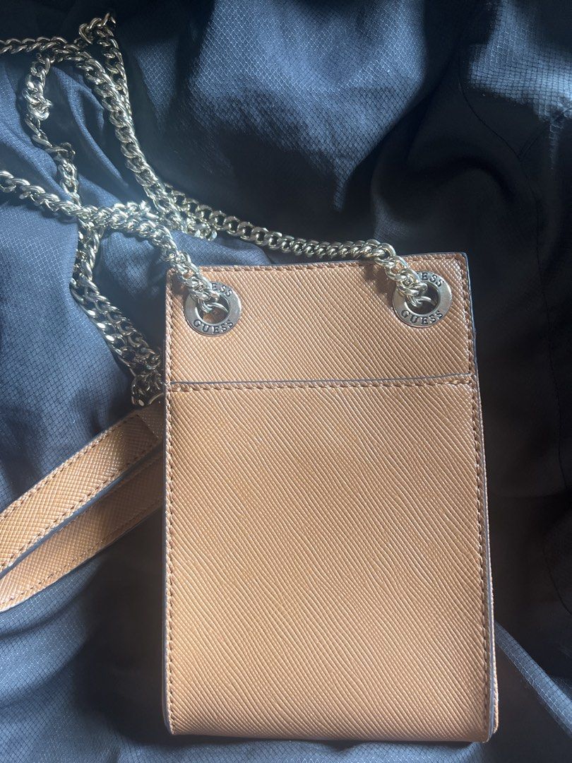 Guess Phone Sling Bag (Category: Cross-body Bags) located in Taguig. Submitted by stuffitlikeitshot (Listing ID 1421958642, Image 3). Description: - Guess phone bag with gold chain strap - Brown color with Guess logo - Multiple compartments for cards and small items - Convenient chain strap for carrying - Used for an event only.