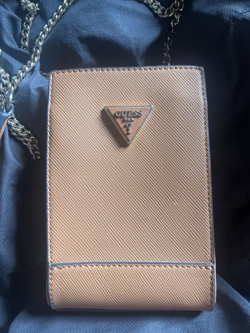 Guess Phone Sling Bag (Category: Cross-body Bags) located in Taguig. Submitted by stuffitlikeitshot (Listing ID 1421958642, Image 2). Description: - Guess phone bag with gold chain strap - Brown color with Guess logo - Multiple compartments for cards and small items - Convenient chain strap for carrying - Used for an event only.