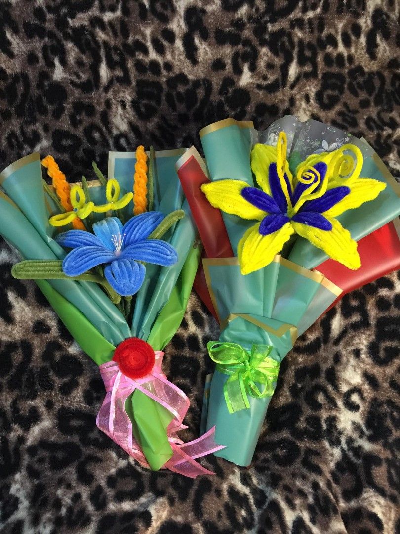 Handmade Pipe Cleaner Flower Bouquet (Category: Flowers & Bouquets) located in Talavera. Submitted by jhaitwist_creations (Listing ID 1422051165, Image 1). Description: - Handmade flower bouquets crafted from pipe cleaners. - Features vibrant yellow and blue flowers. - Wrapped in colorful paper and tied with ribbons. - Perfect for gifts or decorations. - Available in two unique designs. - Charming and creative..