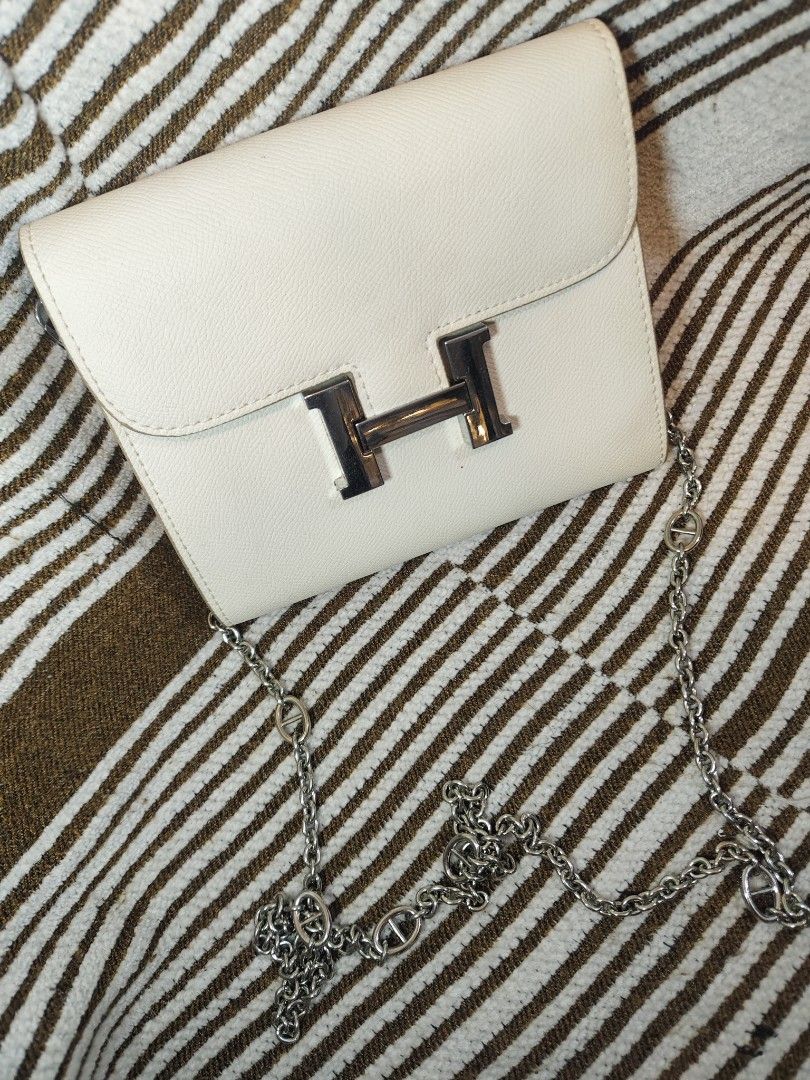 Hermes Style Shoulder Bag with Chain (Category: Luxury Bags & Wallets) located in Paranaque City. Submitted by shopnsaveph (Listing ID 1422071704, Image 3). Description: - Cream-colored shoulder bag - Silver chain strap - Silver 'H' flap closure - Includes orange Hermes shopping bag - Stylish and elegant design - Suitable for various occasions.