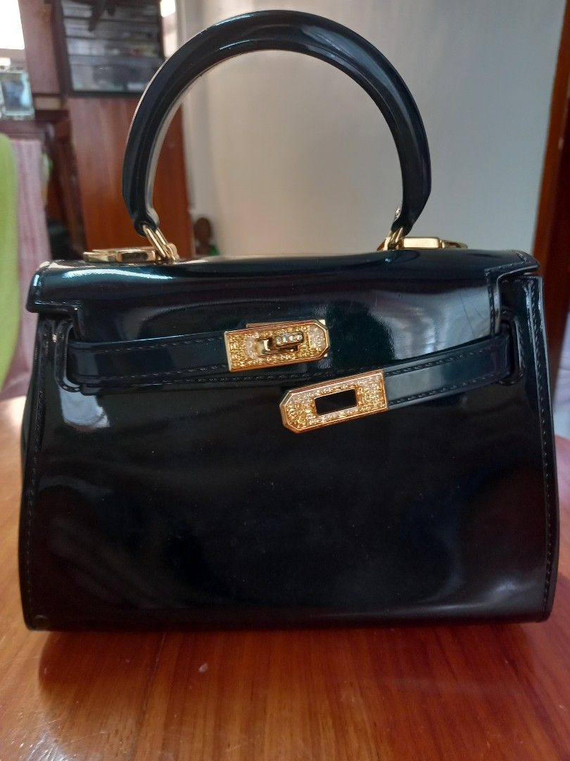 Jelly Toyboy Black Handbag (Category: Luxury Bags & Wallets) located in Manila. Submitted by zenphoenix-7ad615 (Listing ID 1421968653, Image 1). Description: - Jelly Toyboy handbag - Black with gold-colored hardware - Top handle and flap closure - Decorative accents 7 by 6 by 3 inches - Includes chain strap - Glossy patent finish.