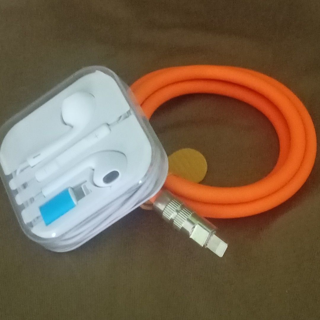 Lightning earphones free charging Cable (Category: Earphones) located in Paranaque City. Submitted by powerzone0517 (Listing ID 1421971916, Image 3). Description: - White EarPods with Lightning connector - Comes in original clear plastic packaging - Orange cable included - Cable has USB and Lightning connectors - Features a leather strap for cable management.