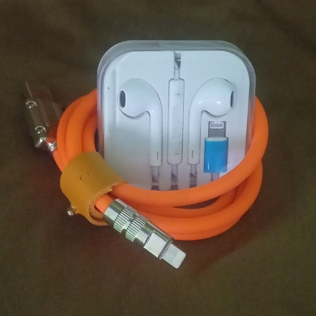 Lightning earphones free charging Cable (Category: Earphones) located in Paranaque City. Submitted by powerzone0517 (Listing ID 1421971916, Image 2). Description: - White EarPods with Lightning connector - Comes in original clear plastic packaging - Orange cable included - Cable has USB and Lightning connectors - Features a leather strap for cable management.