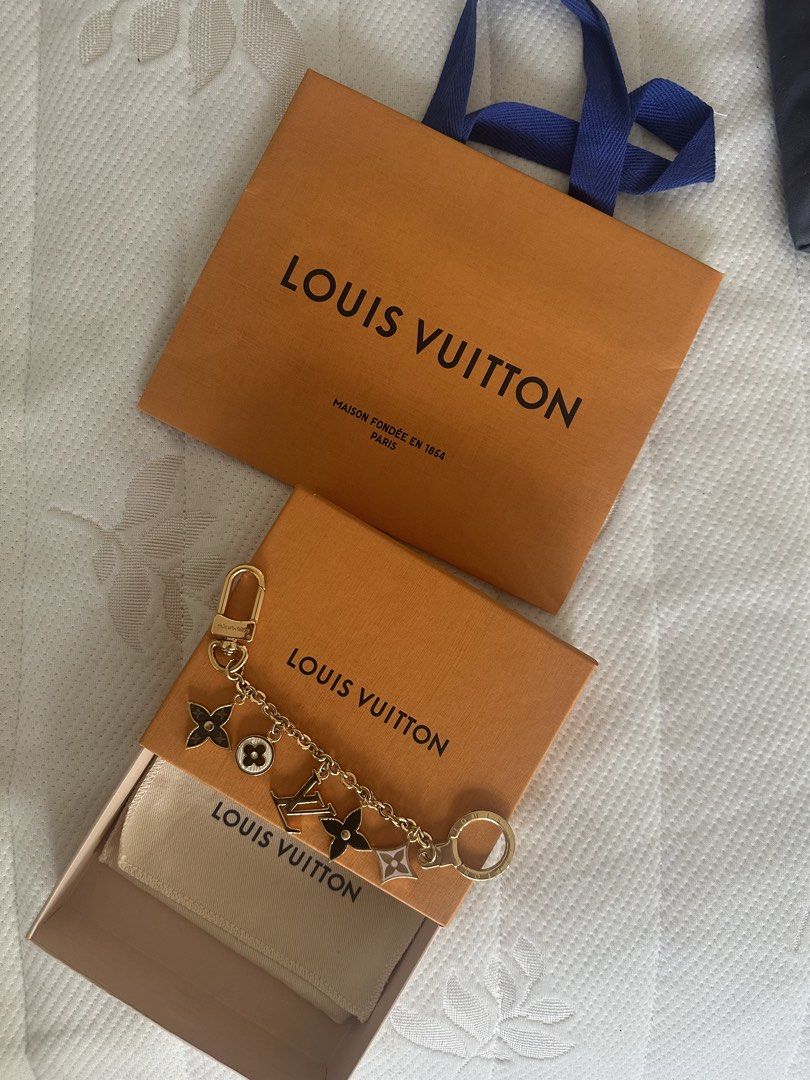 Louis Vuitton Charms Keychain (Category: Luxury Accessories) located in Makati City. Submitted by elenank.595 (Listing ID 1422004258, Image 2). Description: Authentic Louis Vuitton charm keychain. Includes LV logo and Monogram Flower charms. Comes with original box, dust bag, and shopping bag. Gold-tone finish. Perfect for bags or keys. Great for gifts!.