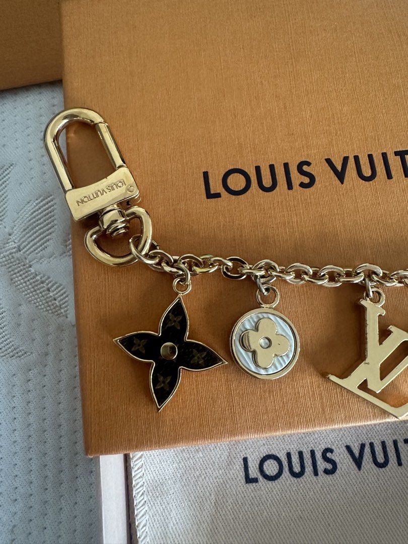 Louis Vuitton Charms Keychain (Category: Luxury Accessories) located in Makati City. Submitted by elenank.595 (Listing ID 1422004258, Image 3). Description: Authentic Louis Vuitton charm keychain. Includes LV logo and Monogram Flower charms. Comes with original box, dust bag, and shopping bag. Gold-tone finish. Perfect for bags or keys. Great for gifts!.