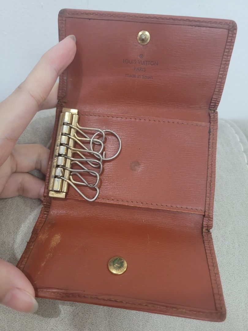 Louis Vuitton Epi Key Holder (Category: Luxury Bags & Wallets) located in Antipolo. Submitted by dlolin (Listing ID 1422066417, Image 3). Description: Authentic Louis Vuitton key holder in Epi leather. Features a snap closure and a key ring with multiple hooks. The interior is lined with leather and includes the Louis Vuitton Paris Made in Spain stamp..