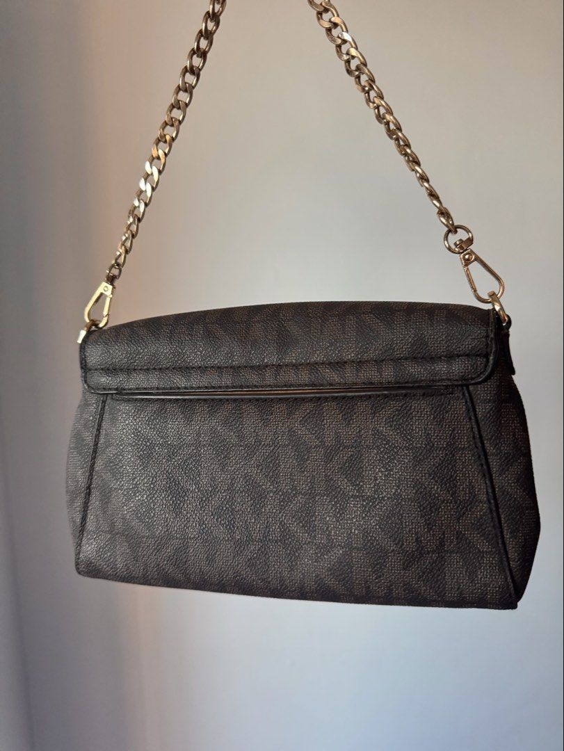 Michael Kors Brown Monogram Crossbody Bag (Category: Luxury Bags & Wallets) located in Quezon City. Submitted by nbg.declutter (Listing ID 1422015473, Image 2). Description: - comes with 2 straps: a chain strap and a detachable brown leather strap - slightly nego for sure buyers - see last photo for minor issue .