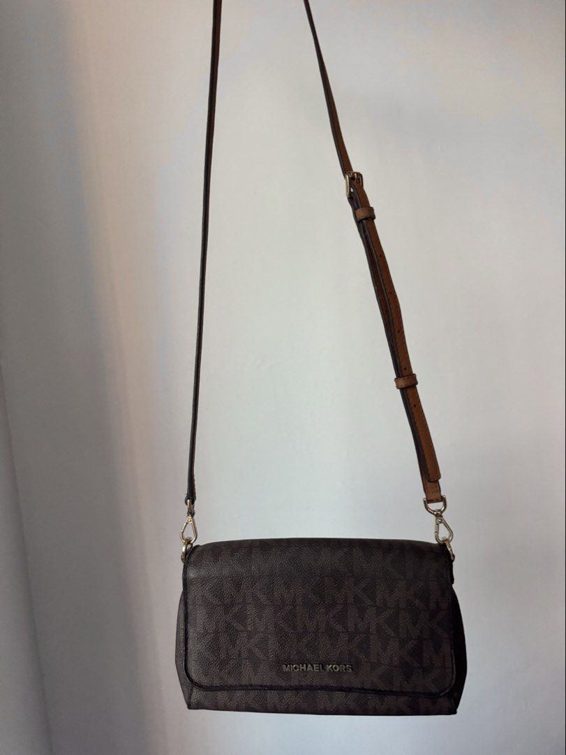 Michael Kors Brown Monogram Crossbody Bag (Category: Luxury Bags & Wallets) located in Quezon City. Submitted by nbg.declutter (Listing ID 1422015473, Image 3). Description: - comes with 2 straps: a chain strap and a detachable brown leather strap - slightly nego for sure buyers - see last photo for minor issue .