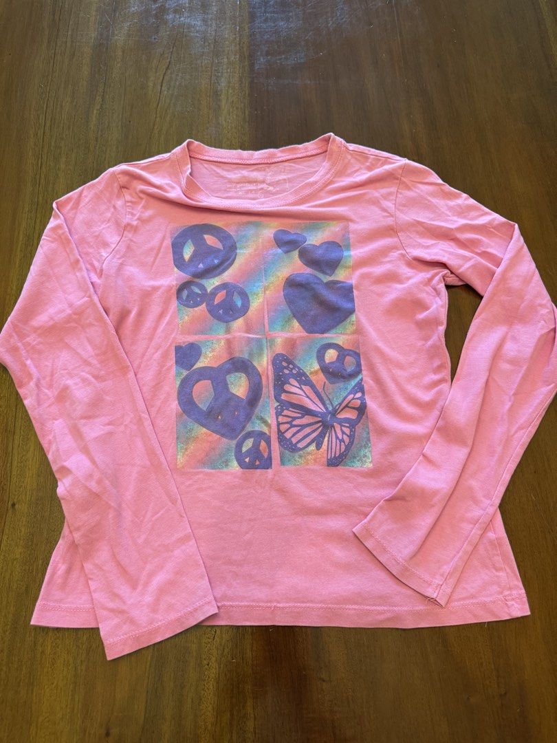 My Perfect Tee Long Sleeve Shirt (Category: Tshirts & Polo Shirts ) located in Mandaue City. Submitted by marginiz (Listing ID 1421954706, Image 1). Description: Pink long-sleeved shirt with a colorful graphic print. The print features peace signs, hearts, and a butterfly. The shirt has a round neckline. The size is XL 14. The shirt is made of a soft material, perfect for everyday wear..