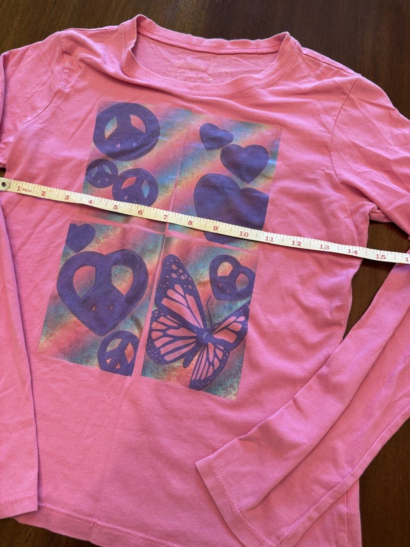 My Perfect Tee Long Sleeve Shirt (Category: Tshirts & Polo Shirts ) located in Mandaue City. Submitted by marginiz (Listing ID 1421954706, Image 2). Description: Pink long-sleeved shirt with a colorful graphic print. The print features peace signs, hearts, and a butterfly. The shirt has a round neckline. The size is XL 14. The shirt is made of a soft material, perfect for everyday wear..